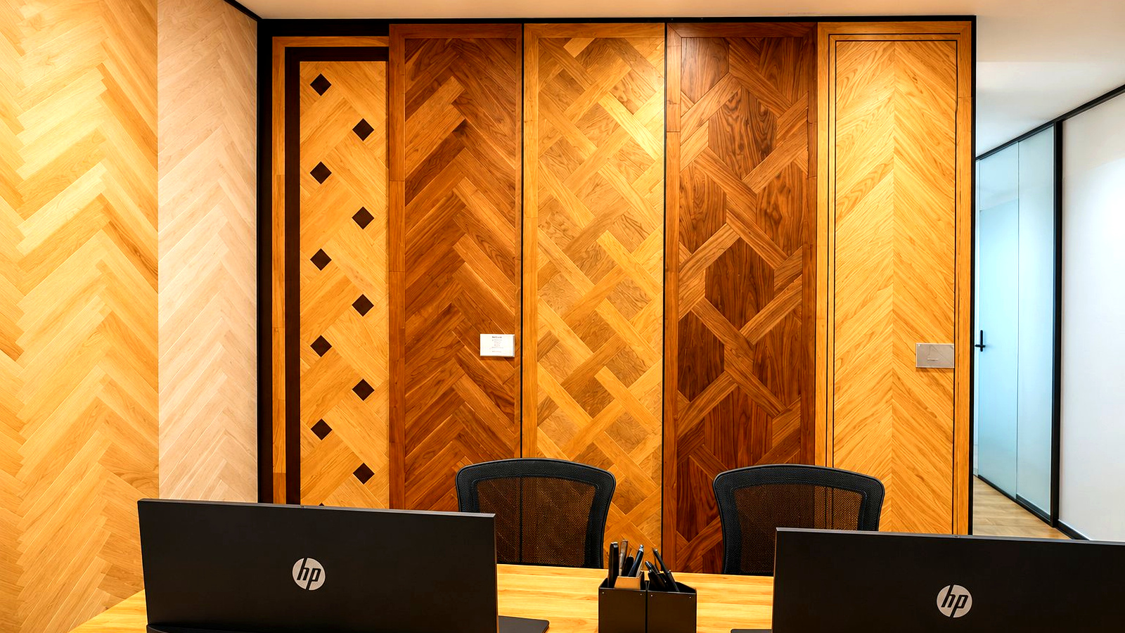 A completed Timberzone Studio interior — bespoke parquet pattern wall in oak and walnut